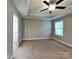 Spacious main bedroom featuring neutral walls, ceiling fan and natural light at 15003 Boudins Ln, Charlotte, NC 28278