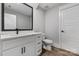 A well-lit bathroom is complemented by white cabinetry, a vanity, and a toilet at 1634 Dresden Dr, Rock Hill, SC 29732