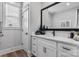 This bathroom offers white cabinets, a vanity, and a rectangular framed mirror at 1634 Dresden Dr, Rock Hill, SC 29732
