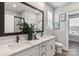 This serene bathroom boasts a double vanity with white cabinets and a large framed mirror at 1634 Dresden Dr, Rock Hill, SC 29732