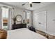 This bedroom is complemented with a dark dresser, hardwood-style flooring, and natural lighting at 1634 Dresden Dr, Rock Hill, SC 29732