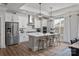 Modern white kitchen featuring an island with counter seating, stainless steel appliances, and pendant lighting at 1634 Dresden Dr, Rock Hill, SC 29732