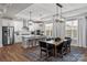 Bright, open kitchen featuring a large island, stainless steel appliances, and modern lighting fixtures at 1634 Dresden Dr, Rock Hill, SC 29732