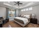A well-lit main bedroom features a ceiling fan, tray ceiling, and complementary furnishings at 1634 Dresden Dr, Rock Hill, SC 29732