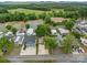 Expansive aerial view of a well maintained mobile home community with mature trees at 165 Cardinal Dr # 615, New London, NC 27371