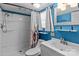 Stylish bathroom with blue accent wall, white vanity and shower with decorative curtain at 165 Cardinal Dr # 615, New London, NC 27371