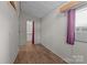 Bedroom featuring neutral walls, wood-look flooring, and window with blinds and mauve curtains at 165 Cardinal Dr # 615, New London, NC 27371