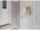 Bright entryway features tile floors and a white exterior door with glass window at 165 Cardinal Dr # 615, New London, NC 27371