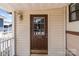 Close-up view of the front door with a window, showing the house number 165 and exterior details at 165 Cardinal Dr # 615, New London, NC 27371
