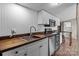Galley style kitchen featuring stainless steel appliances and butcher block countertops at 165 Cardinal Dr # 615, New London, NC 27371