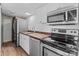 Efficient kitchen with stainless steel appliances, butcher block countertops, and ample lighting at 165 Cardinal Dr # 615, New London, NC 27371