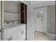 Well-lit laundry room with tile floors, white washer and dryer, and a white exterior door at 165 Cardinal Dr # 615, New London, NC 27371