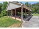 Open-air pavilion with picnic tables and a brick fireplace in a community park setting at 165 Cardinal Dr # 615, New London, NC 27371