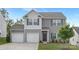 Charming two-story home featuring a two-car garage, gray siding, shutters, and a well-manicured front lawn at 165 Clove Hitch Dr # I281, Statesville, NC 28677
