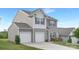 A two-story home showing the driveway and garage with light gray siding, blue shutters, and a gabled roof at 165 Clove Hitch Dr # I281, Statesville, NC 28677