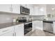 Bright kitchen featuring white cabinets, stainless steel appliances, and granite countertops at 165 Clove Hitch Dr # I281, Statesville, NC 28677