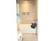 Clean and tidy bathroom features tiled walls, a bathtub, and storage shelves at 1727 Grace Ln, Charlotte, NC 28262