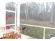 Enjoy the outdoors on this screened porch featuring a table with wooded view at 1727 Grace Ln, Charlotte, NC 28262