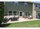 Cozy backyard patio with comfortable seating, a fire pit, and lush green grass at 1809 Evergreen Dr, Charlotte, NC 28208