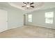 Spacious bedroom with ceiling fan and two windows at 1809 Evergreen Dr, Charlotte, NC 28208