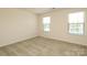 Light and airy bedroom with neutral carpet and two windows at 1809 Evergreen Dr, Charlotte, NC 28208