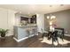 Cozy dining area with hardwood floors, a modern chandelier, bar stool seating, and seamless access to the kitchen at 1809 Evergreen Dr, Charlotte, NC 28208