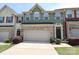 Charming townhome featuring a neutral garage door, brick accents, and manicured landscaping in a desirable community at 1809 Evergreen Dr, Charlotte, NC 28208