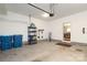 Clean garage with ample storage space, shelving, and access to an indoor area at 1809 Evergreen Dr, Charlotte, NC 28208