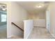 Upstairs hallway with carpet leads to bedrooms at 1809 Evergreen Dr, Charlotte, NC 28208