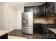 Well-equipped kitchen showcasing stainless steel appliances, dark cabinets, and a functional layout at 1809 Evergreen Dr, Charlotte, NC 28208