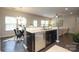 Stylish kitchen with stainless steel appliances, dark cabinetry, and a view into the adjacent dining area and living room at 1809 Evergreen Dr, Charlotte, NC 28208