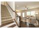 Open floor plan with hardwood floors flowing from entry to living room with ceiling fan at 1809 Evergreen Dr, Charlotte, NC 28208