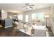 Bright open-concept living room with hardwood floors, lots of natural light, and a view into the dining area at 1809 Evergreen Dr, Charlotte, NC 28208