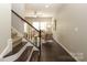 Inviting living room featuring hardwood floors, a ceiling fan, and staircase leading to the upper level at 1809 Evergreen Dr, Charlotte, NC 28208