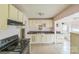 Spacious kitchen featuring tile floors, cream colored cabinets and black appliances at 1908 5Th St, Statesville, NC 28677