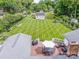 Expansive fenced backyard with a shed and striped lawn, seen from a wooden deck with an umbrella and furniture at 195 Brookfield Cir, Mooresville, NC 28115