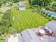 Aerial view of large manicured backyard with a deck, outbuildings, a pool, and lush green grass at 195 Brookfield Cir, Mooresville, NC 28115
