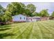 Well-maintained backyard with a large deck, screened porch, and lush green lawn at 195 Brookfield Cir, Mooresville, NC 28115