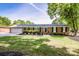 Beautiful brick home with a well-manicured lawn, shrubs, and a two-car garage on a sunny day at 195 Brookfield Cir, Mooresville, NC 28115