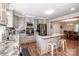 Well-lit kitchen features stainless appliances, island, and open dining at 195 Brookfield Cir, Mooresville, NC 28115