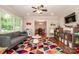 Bright playroom with a ceiling fan, wood floors, and colorful decor, adjacent to the dining area at 195 Brookfield Cir, Mooresville, NC 28115