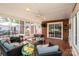 Enclosed screened porch with comfortable seating and a brick accent wall at 195 Brookfield Cir, Mooresville, NC 28115