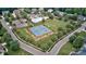 Community aerial featuring tennis courts, pool, and green space surrounded by mature trees and neighborhood homes at 212 Forest Walk Way, Mooresville, NC 28115
