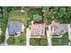 Aerial view of the home's landscaped yard with a patio, and a well-maintained lawn surrounded by mature trees at 212 Forest Walk Way, Mooresville, NC 28115