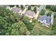 Areal view showcasing the backyard, which features a patio, mature trees and lush greenery at 212 Forest Walk Way, Mooresville, NC 28115