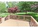 A wood deck overlooks a large backyard with mature trees and a decorative red Japanese maple tree at 212 Forest Walk Way, Mooresville, NC 28115