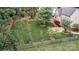 Lush backyard featuring mature trees, green grass, a patio with furniture, and a charming wooden fence at 212 Forest Walk Way, Mooresville, NC 28115