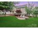 Large backyard featuring a patio, mature trees, privacy fence, and well-maintained lawn at 212 Forest Walk Way, Mooresville, NC 28115