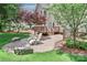 Backyard patio with beautiful landscaping and outdoor seating, ideal for relaxing and entertaining guests at 212 Forest Walk Way, Mooresville, NC 28115