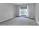 Neutral bedroom with a large window and plush gray carpeting, creating a cozy and inviting atmosphere at 212 Forest Walk Way, Mooresville, NC 28115